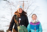 A mom and daughter on a winter walk.